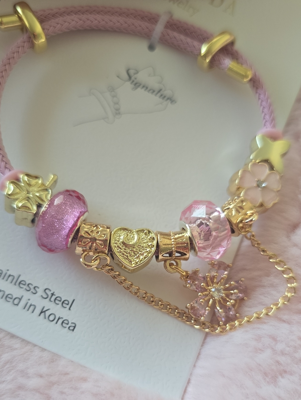 Signature Pink and Gold Charm Bracelet with Floral Accents